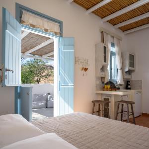 a bedroom with a bed and an open door at Toffee in Kimolos