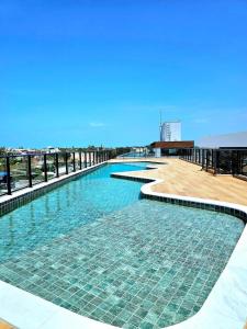 a large swimming pool on top of a building at Porto City - Flat 06 com Jacuzzi in Porto De Galinhas