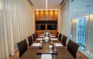 a conference room with a long table and chairs at Hyatt Vancouver Downtown Alberni in Vancouver +91 photos