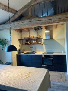 a kitchen with a sink and a stove at gîte chêne doré in Ribérac