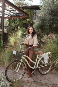 a woman is standing next to a bike at Blumen Hotel Boutique in Canela