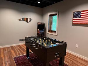 a room with a chess board and an american flag at Stoney Brook Cabin in Boone