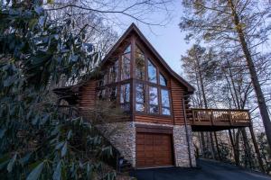 a house with a wrap around porch and a deck at Stoney Brook Cabin in Boone