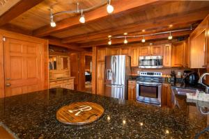 a kitchen with wooden cabinets and a granite counter top at Stoney Brook Cabin in Boone