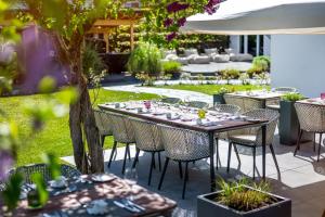 a table and chairs in a garden with a table at Moselromantik Hotel Kessler Meyer - Adults Only in Cochem