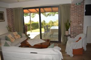 a living room with a teddy bear sitting on a couch at Thalantheia House in Agios Konstantinos