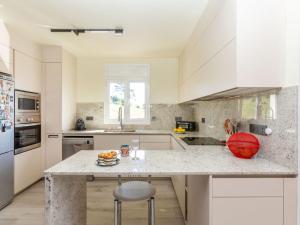 a kitchen with white cabinets and a marble counter top at Holiday Home Figaro by Interhome in Blanes