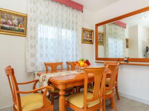 a dining room with a table and chairs and a mirror at Holiday Home Figaro by Interhome in Blanes