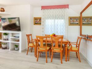 a dining room with a wooden table and chairs at Holiday Home Figaro by Interhome in Blanes