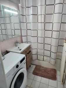a bathroom with a washing machine and a sink at Champions Deluxe in Sarcelles +65 photos