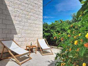 two chairs and a table on a patio at Holiday Home Bila Vila by Interhome in Zadar