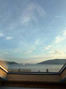 a view of the ocean from a window at Lumier Apartment in Zelenika
