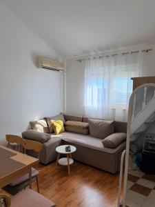 a living room with a couch and a table at Lumier Apartment in Zelenika