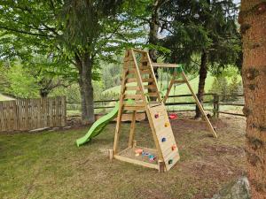 a wooden playground with a ladder and a slide at Almhütte, Ferienhaus Hadn Hube in Paisberg