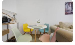 a room with a table and chairs and a couch at Downtown Apartment in Bonn