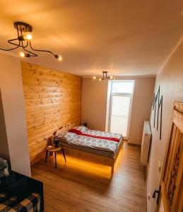 a bedroom with a bed in a room with wooden walls at Apartament Oravski, blisko Term Chochołowskich, Tatry i Oravice, cisza, widok, parking in Suchá Hora +41 photos