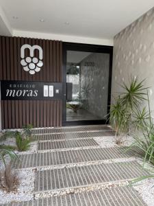 a front door of a building with a sign on it at Moras Urban in Esperanza