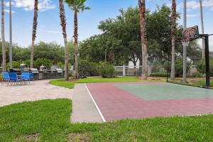 a basketball hoop in a park with palm trees at Hawthorn Suites Suite Near Universal & I-Drive in Orlando
