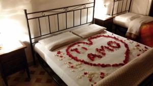 a large cake on a bed with roses on it at Affittacamere Cà Marcello in Monselice