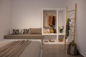 a bedroom with a bed and a closet at Blue Cyclades Villas in Kastraki