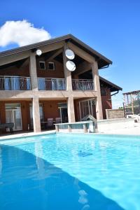 a large swimming pool in front of a building at SIBE Apartments in Banja Luka