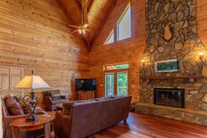 a living room with a couch and a fireplace at Sunset View Lodge in Elk Park