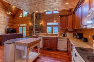 a kitchen with wooden cabinets and a wooden floor at Sunset View Lodge in Elk Park