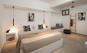 a white bedroom with a large bed in it at Blue Cyclades Villas in Kastraki