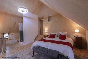 a large bedroom with a large bed with red pillows at RELAI VALDIEU in Courgeon