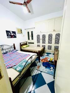 a room with two beds and a ceiling fan at شاليه in Dawwār Abū Maḩrūs