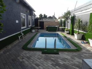 a swimming pool in the middle of a backyard at Gold Crown International Hotel Johannesburg in Johannesburg