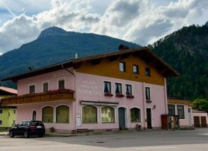 a building with a car parked in front of it at Ferienwohnung Sonnweber in Stanzach