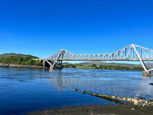 a bridge over a river with blue water at The Rowans B&B in Connel