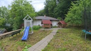 a yard with a slide and a playground at Pensiunea Diskret in Sovata