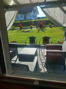 a view of a patio with tables and chairs at Domek Pod Prehybą -Agroturystyka in Gaboń