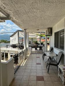 a balcony with a table and chairs and a view at Apartmani Bjelila in Tivat