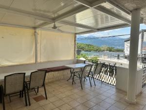 a patio with a table and chairs on a balcony at Apartmani Bjelila in Tivat +2 photos