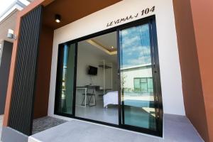 a glass door leading to a bedroom in a house at Baan Le Vimaan in Nakhon Ratchasima