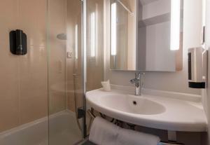 a bathroom with a sink and a shower at B&B HOTEL Beauvais in Beauvais