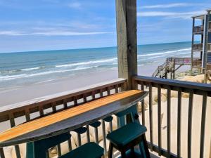 a balcony with a bench and the beach at Steps to the Ocean! 219 in North Topsail Beach