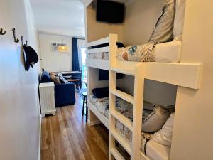 a room with two bunk beds in a room at Steps to the Ocean! 219 in North Topsail Beach