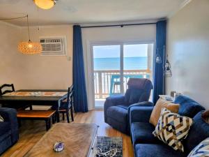 a living room with a view of the ocean at Steps to the Ocean! 219 in North Topsail Beach