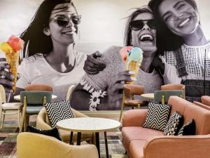 a group of three women holding ice cream cones at ibis Styles Bournemouth in Bournemouth
