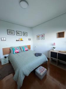 a bedroom with a large bed and a desk at Ibinaga Seaview - Auto checking property in Ibarrangelu