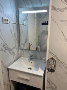 a bathroom with a white sink and a mirror at Ibinaga Seaview - Auto checking property in Ibarrangelu +29 photos