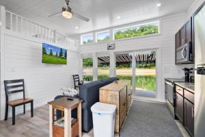 a kitchen and living room in a tiny house at Miss Madison - Pet Friendly Floating House in Russell Springs