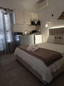 a bedroom with a large bed with towels on it at Iason studio 1 in Patitiri