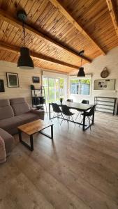a living room with a couch and a table at Carpinus I domek nad jeziorem in Łętowo +10 photos