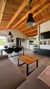 a living room with a couch and a table at Carpinus I domek nad jeziorem in Łętowo
