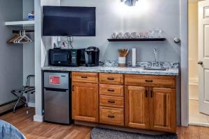 a kitchen with a sink and a microwave at Champagne Supernova in Ludlow